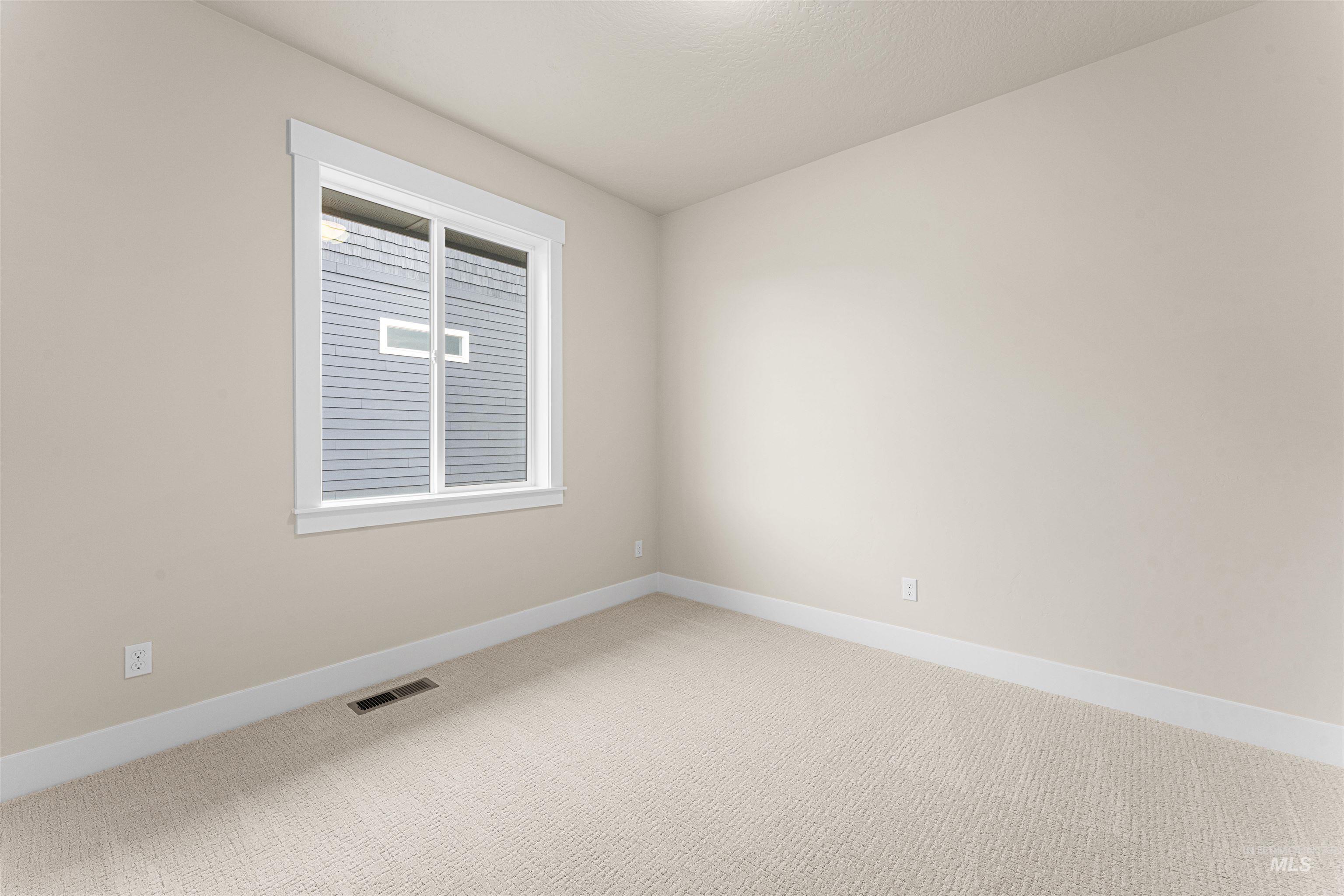 8078 Tandy Cv Street Middleton, ID 83644 - Photo 32 of 40 Spare room with light carpet and baseboards
