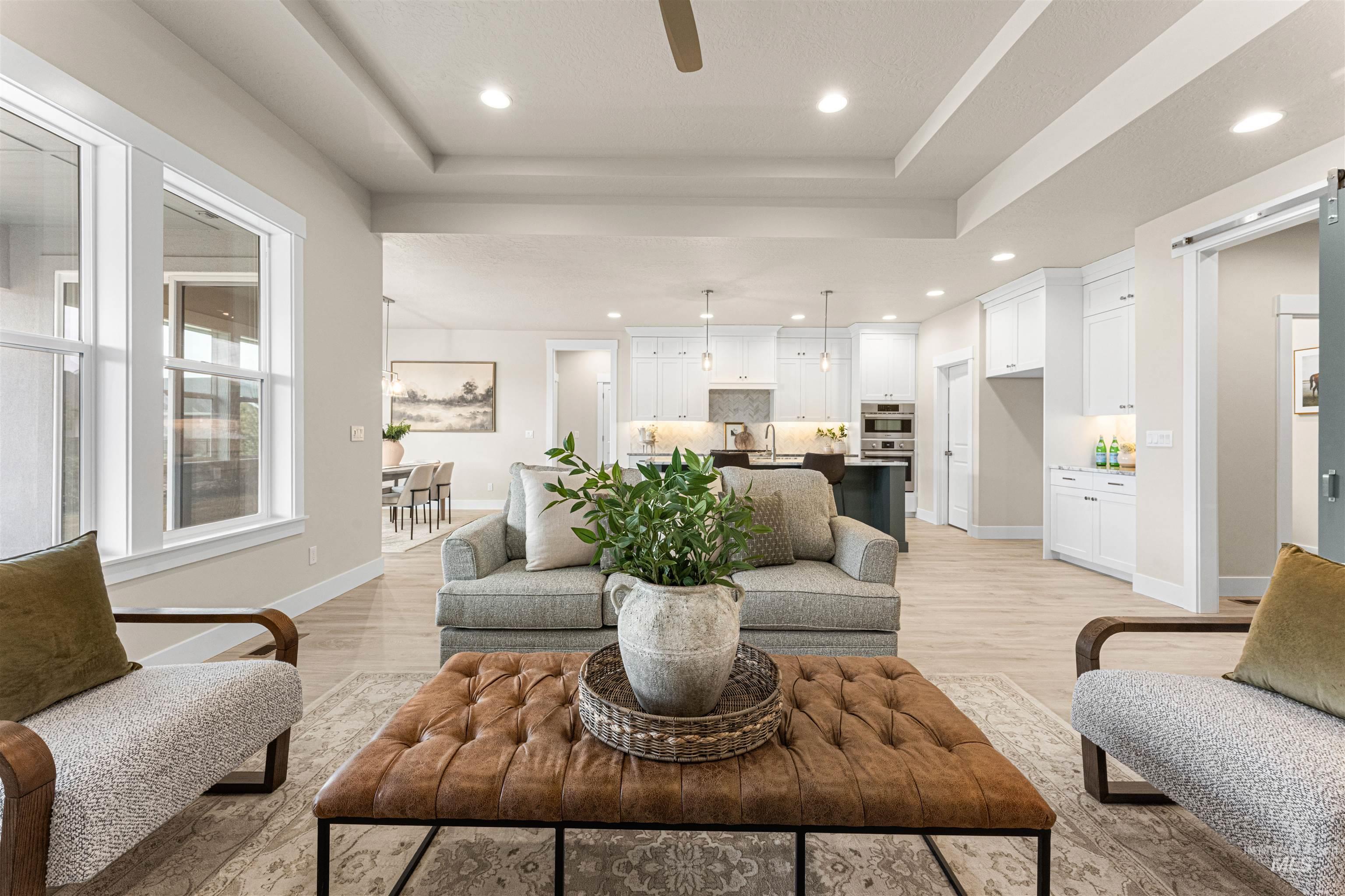 8078 Tandy Cv Street Middleton, ID 83644 - Photo 6 of 40 Living room featuring light wood finished floors, a ceiling fan, recessed lighting, and a raised ceiling