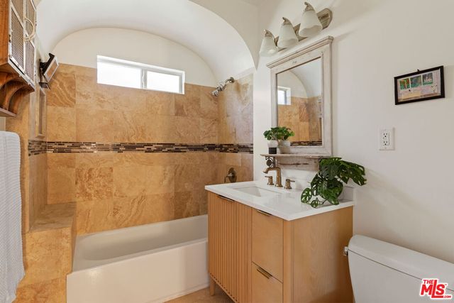 a bedroom with furniture and a window