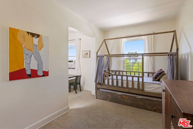 a view of a patio with couches table and chairs and potted plants
