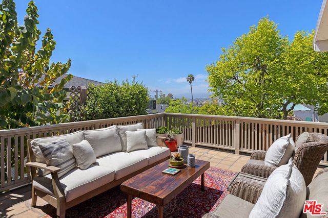 a view of a backyard with wooden fence and a bench