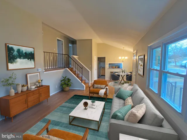 a living room with furniture fireplace and a table