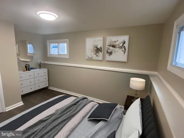 a view of bedroom with furniture and wooden floor