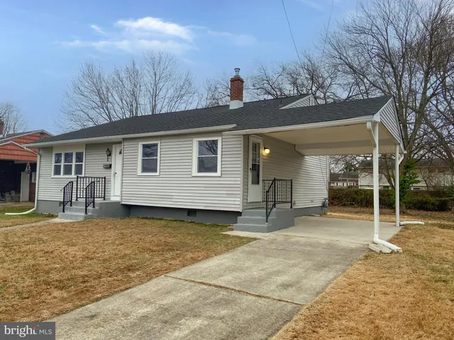 a view of a house with a patio and backyard of house