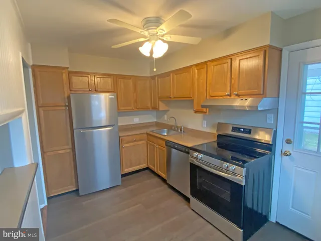 a kitchen with a refrigerator sink and cabinets