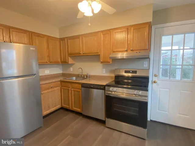 a kitchen with a stove top oven sink and refrigerator