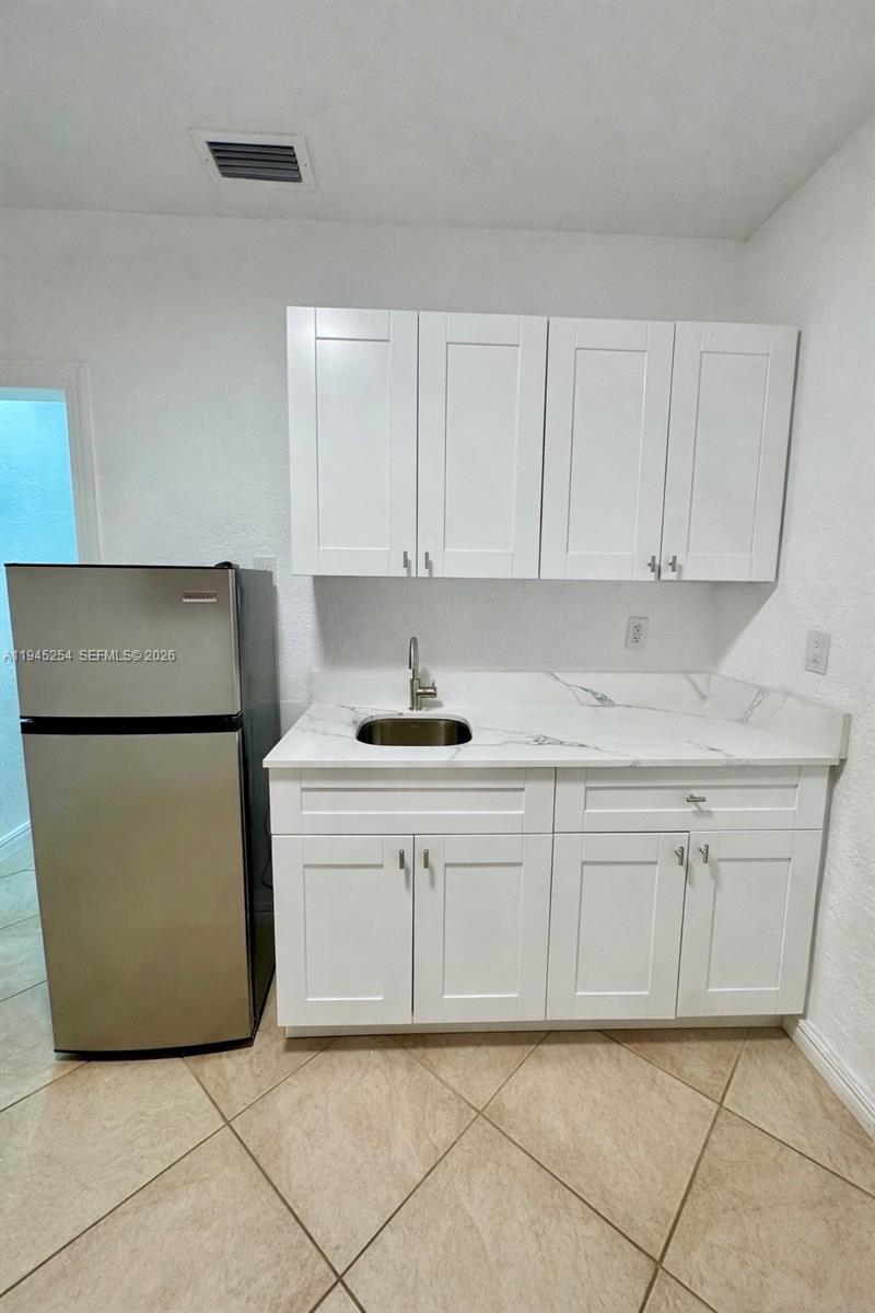 a kitchen with cabinets and white appliances