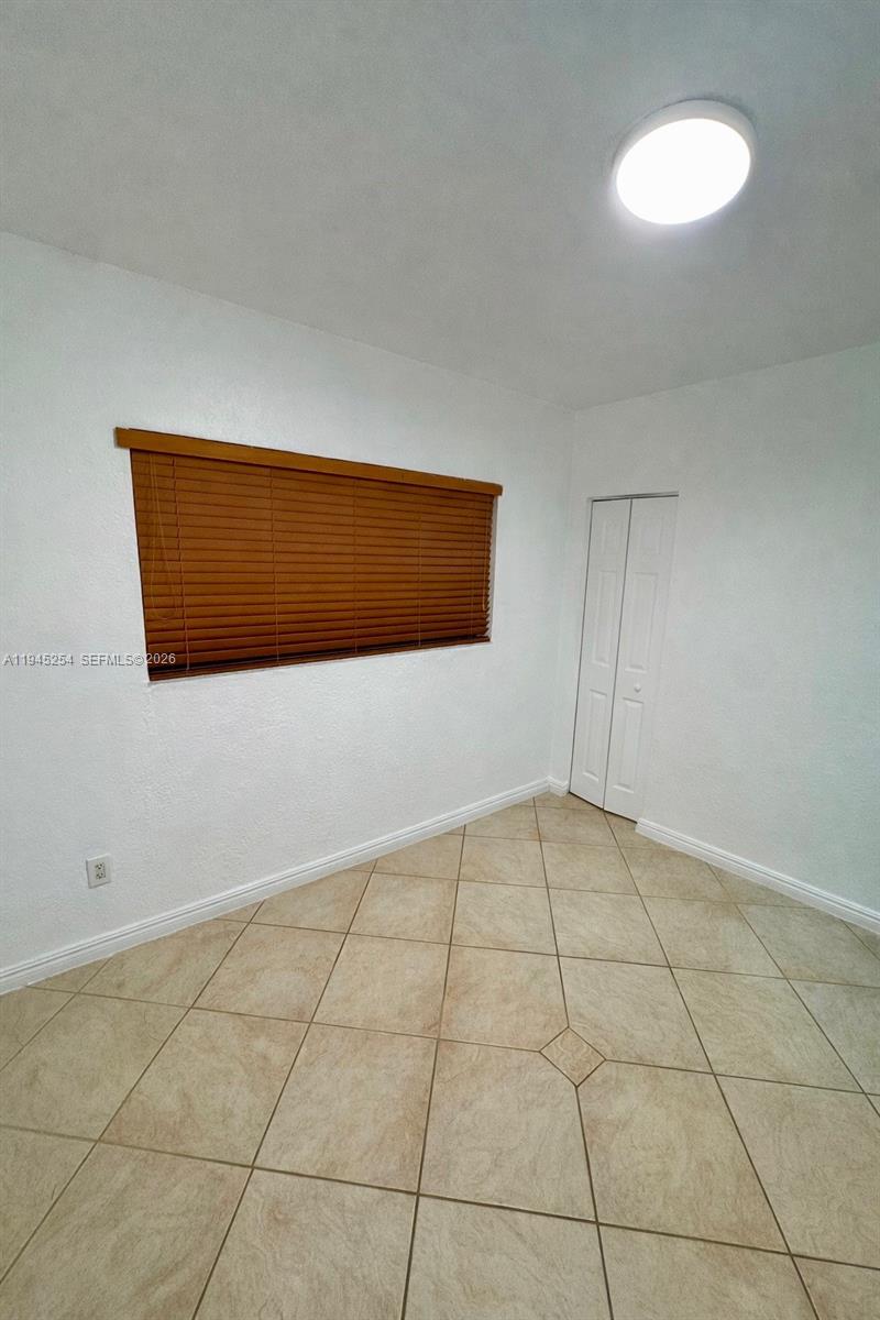 6541 West 11th Court, Unit 1 Hialeah, FL 33012 - Photo 3 of 6 a view of an empty room with a window