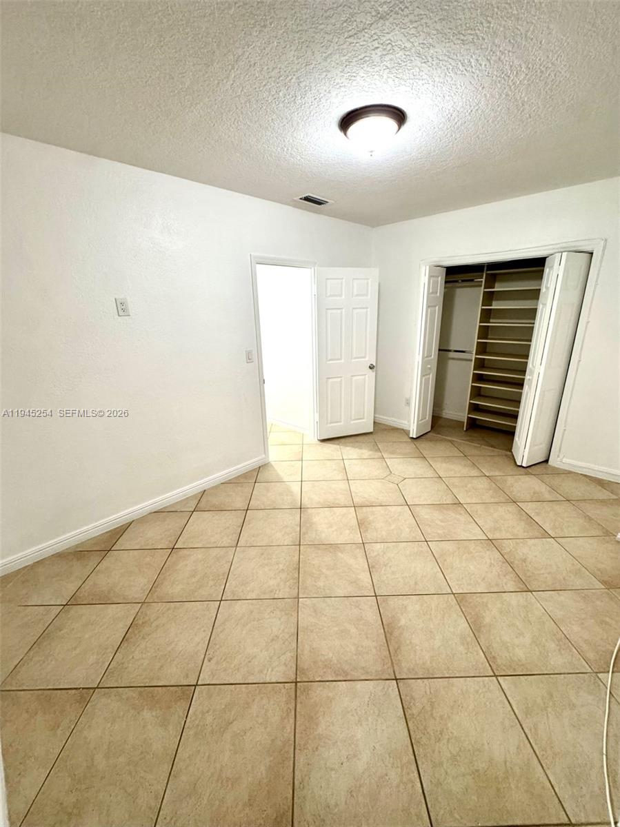 6541 West 11th Court, Unit 1 Hialeah, FL 33012 - Photo 4 of 6 a view of an empty room with a window