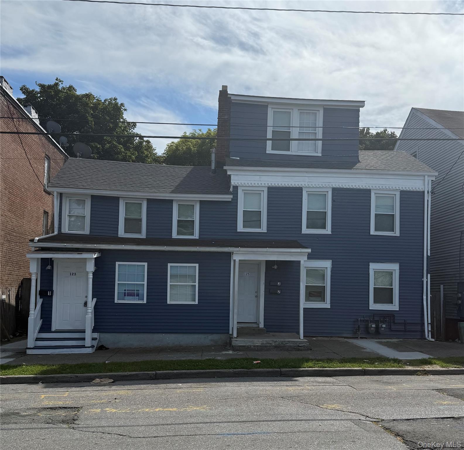 View of front of house with a shingled roof