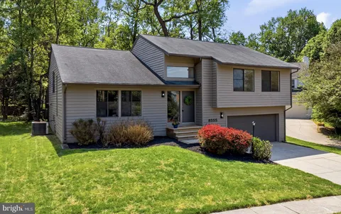 a front view of a house with a garden and yard