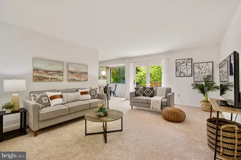a living room with furniture and a table