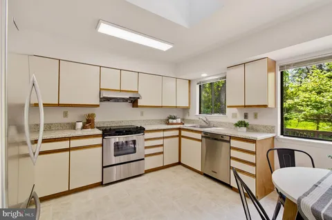 a kitchen with a table chairs and window