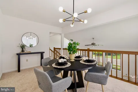a view of a dining room with furniture and a chandelier