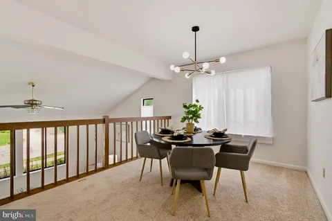 a view of a dining room with furniture and chandelier