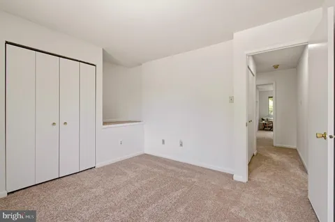 a bedroom with bed and a large window