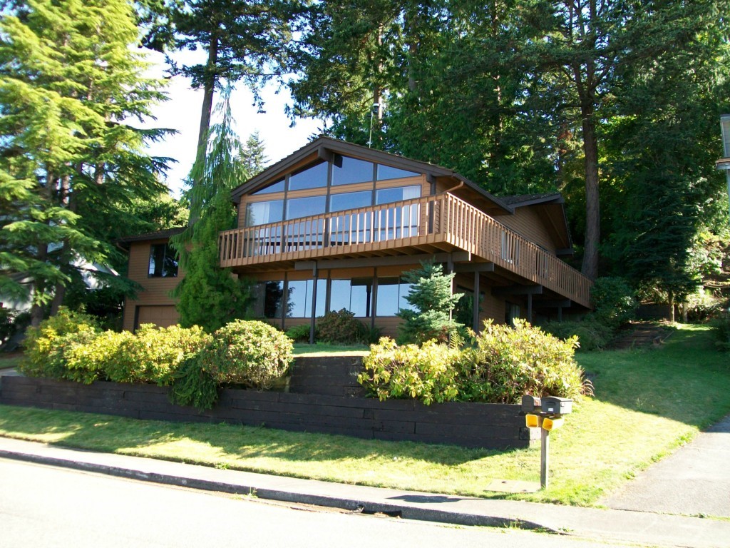 216 Bayside Road Bellingham, WA 98225 - Photo 1 of 1 a front view of a house with a yard with yellow lighting