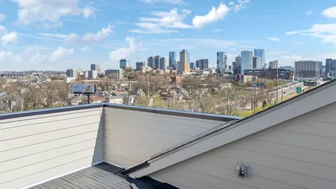 a view of a white building with a view of a balcony