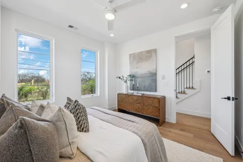 a bedroom with a bed couch and a window