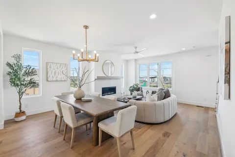 a living room with fireplace furniture and a chandelier