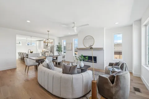 a living room with furniture a fireplace and a large window