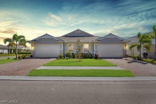 a front view of a house with a yard and garage