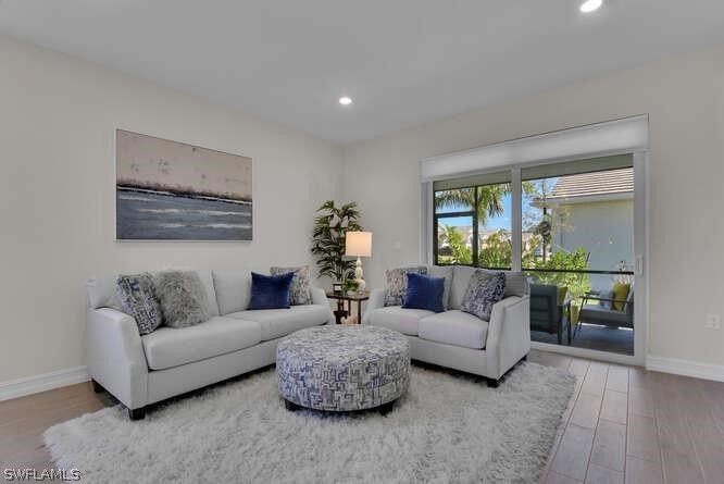 1064 Tranquil Brook Drive Naples, FL 34114 - Photo 11 of 28 a living room with furniture and a large window