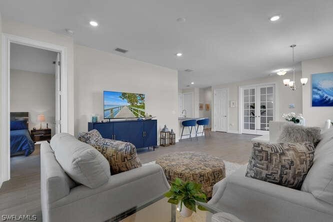 1064 Tranquil Brook Drive Naples, FL 34114 - Photo 12 of 28 a living room with furniture and kitchen view