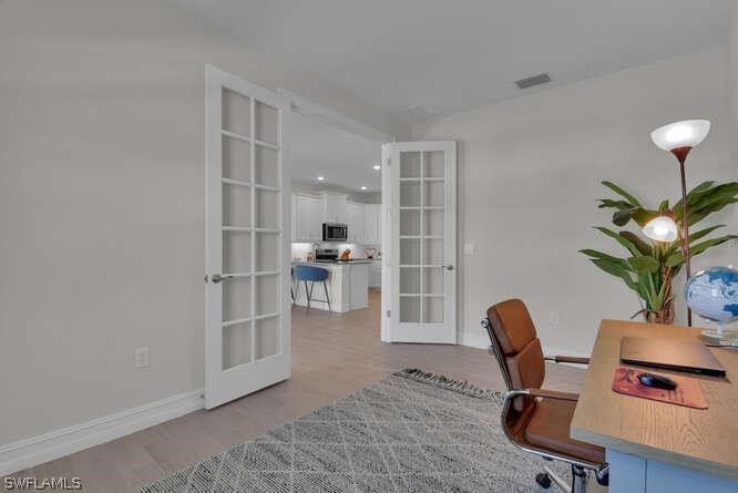 1064 Tranquil Brook Drive Naples, FL 34114 - Photo 13 of 28 a view of a workspace with furniture and a potted plant
