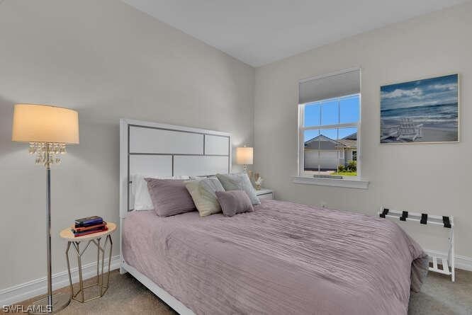 1064 Tranquil Brook Drive Naples, FL 34114 - Photo 18 of 28 a bedroom with a bed and a lamp