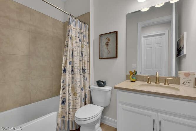 1064 Tranquil Brook Drive Naples, FL 34114 - Photo 19 of 28 a bathroom with a sink a toilet and shower