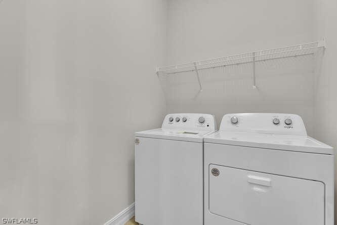 1064 Tranquil Brook Drive Naples, FL 34114 - Photo 20 of 28 a utility room with dryer and washer