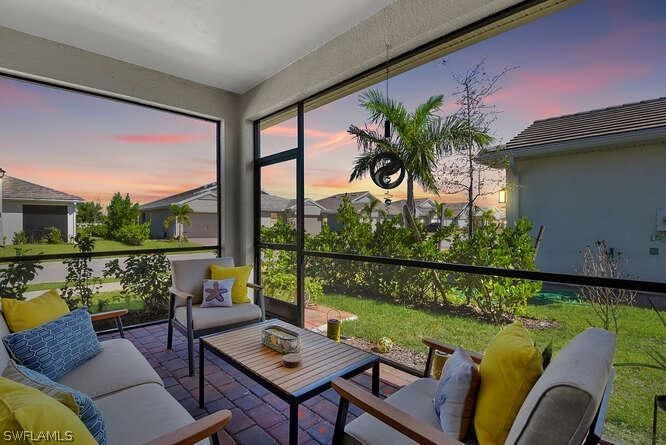 1064 Tranquil Brook Drive Naples, FL 34114 - Photo 21 of 28 a outdoor living room with furniture