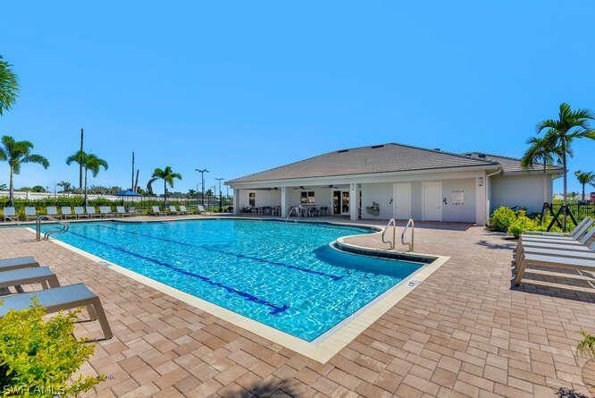 1064 Tranquil Brook Drive Naples, FL 34114 - Photo 24 of 28 a front view of house with yard and outdoor seating