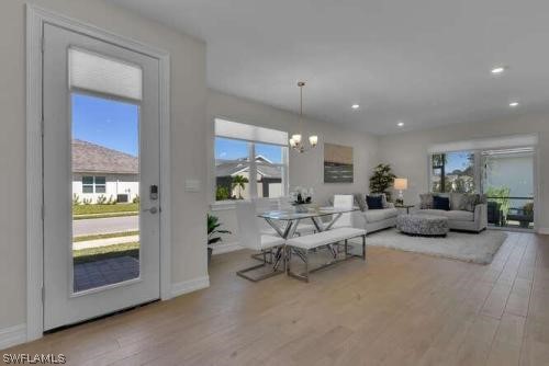 1064 Tranquil Brook Drive Naples, FL 34114 - Photo 4 of 28 a living room with furniture and a window