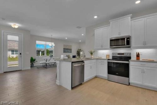 1064 Tranquil Brook Drive Naples, FL 34114 - Photo 7 of 28 a kitchen with sink cabinets and microwave