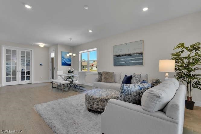 1064 Tranquil Brook Drive Naples, FL 34114 - Photo 10 of 28 a living room with furniture and a potted plant