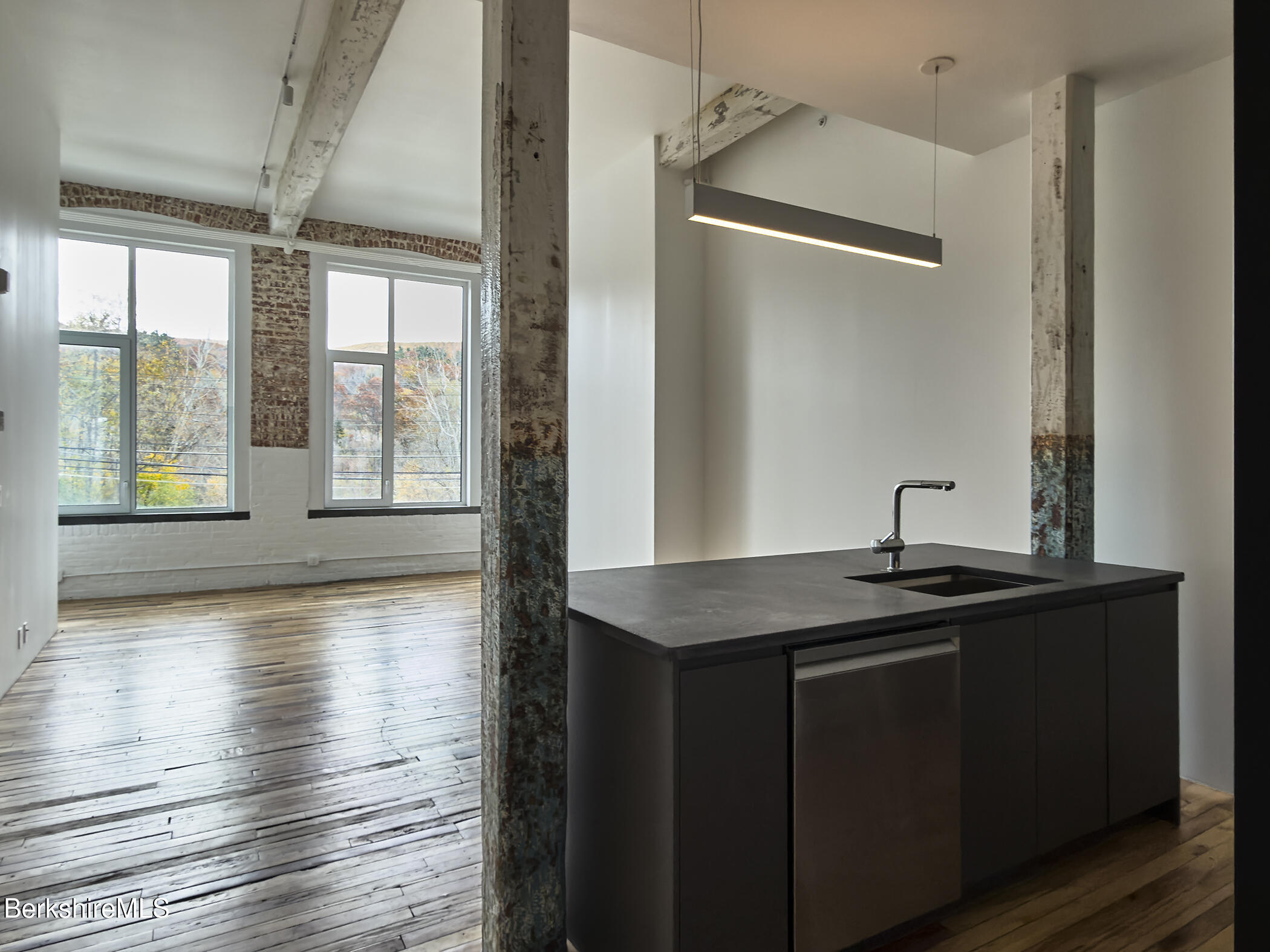 520 State Road, Unit 208 North Adams, MA 01247 - Photo 9 of 38 a kitchen with granite countertop a sink and wooden floor
