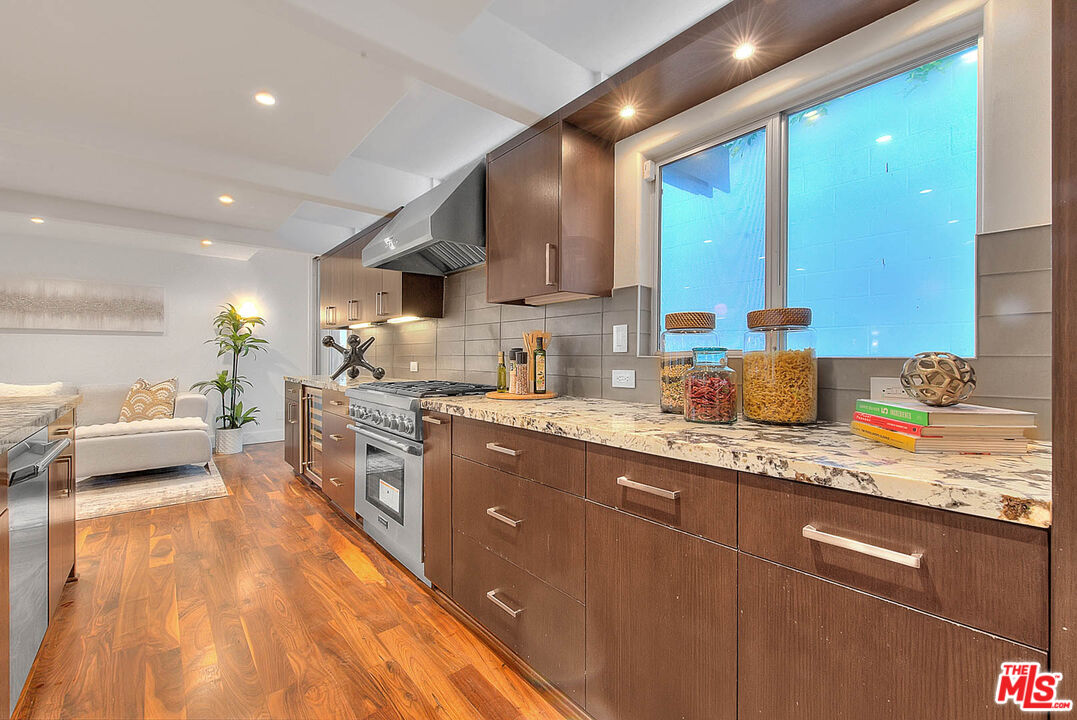 3804 Duray Place Los Angeles, CA 90008 - Photo 28 of 73 a kitchen with stainless steel appliances granite countertop wooden cabinets a sink dishwasher a stove and a refrigerator
