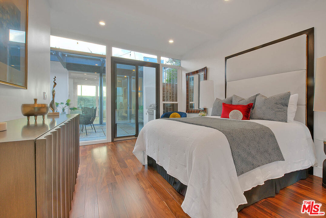 3804 Duray Place Los Angeles, CA 90008 - Photo 37 of 73 a bedroom with a large bed and a chandelier