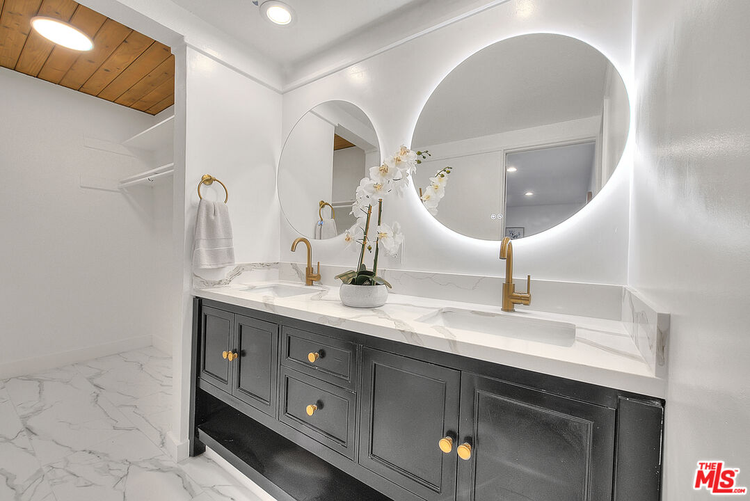 3804 Duray Place Los Angeles, CA 90008 - Photo 42 of 73 a bathroom with a double vanity sink and a mirror