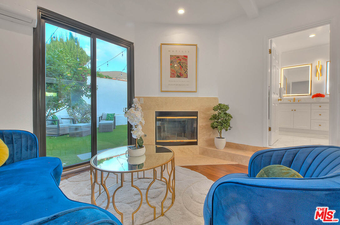 3804 Duray Place Los Angeles, CA 90008 - Photo 51 of 73 a living room with furniture a flat screen tv and a fireplace