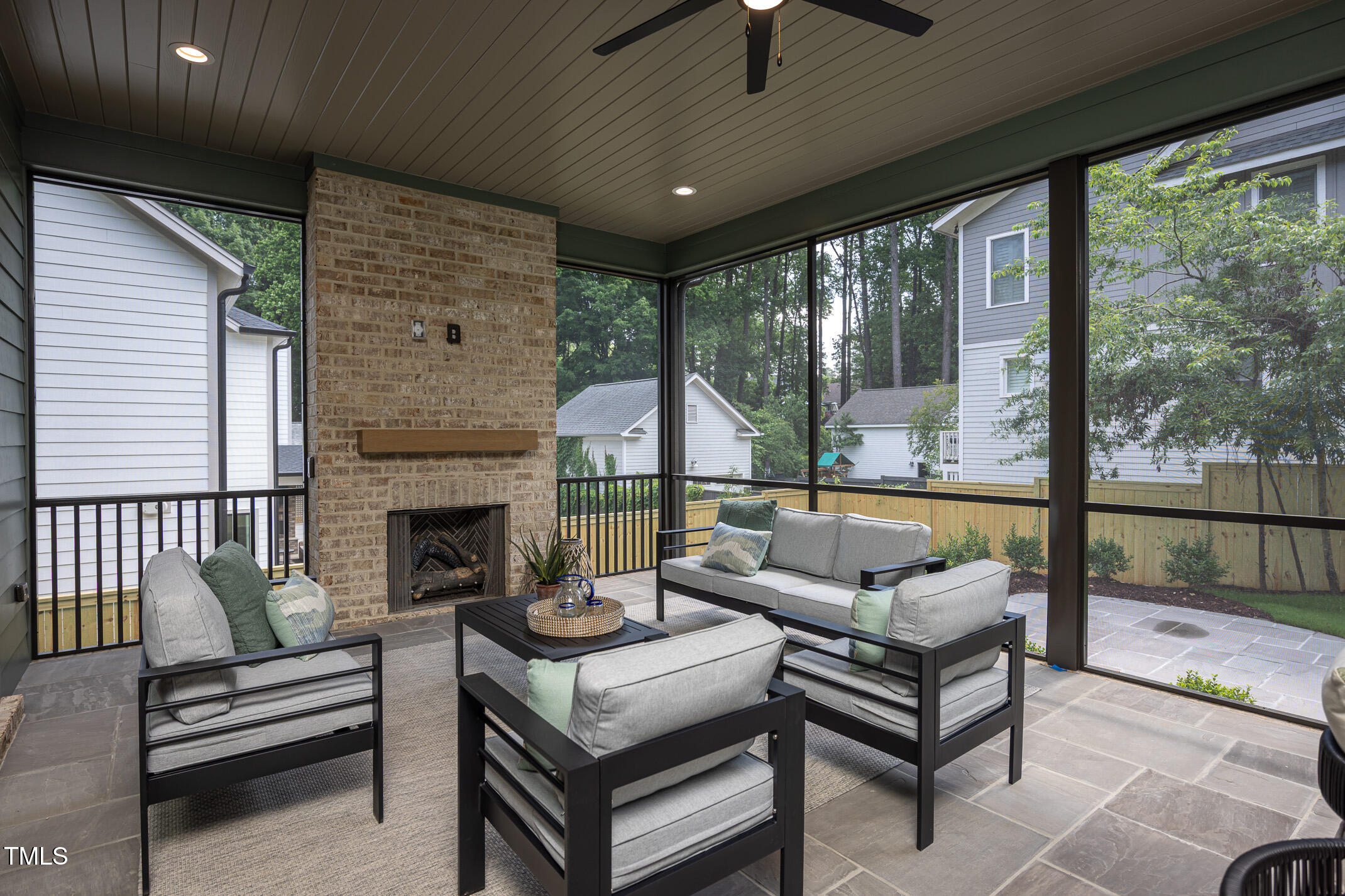 1000 Marilyn Drive Raleigh, NC 27607 - Photo 14 of 59 Large flagstone screened porch with fireplace and plenty of spaces for dining and relaxing.