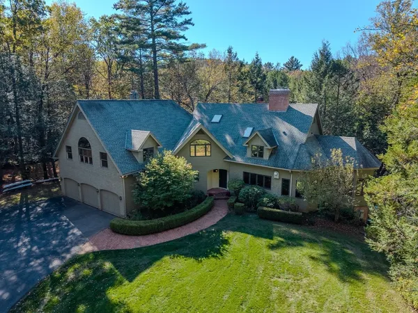 a aerial view of a house with swimming pool next to a yard