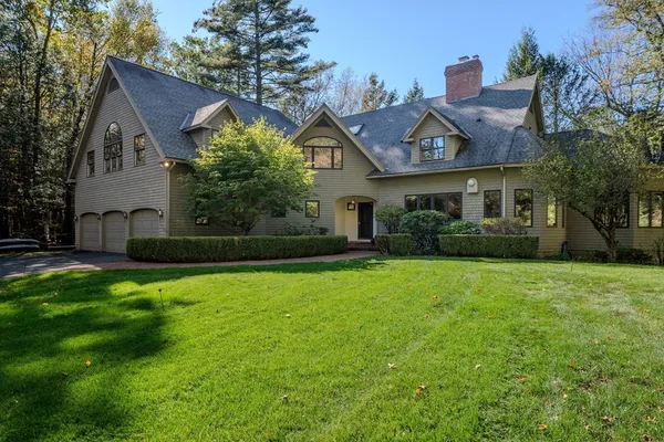 a front view of house with yard and green space