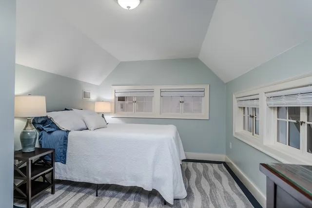 a bathroom with a granite countertop bathtub sink vanity mirror and toilet