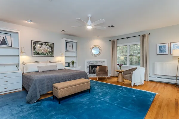 a spacious bedroom with a bed and a chandelier