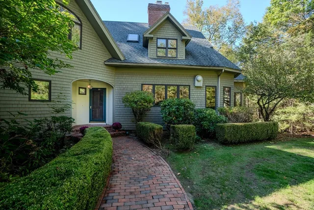 a front view of a house with a garden