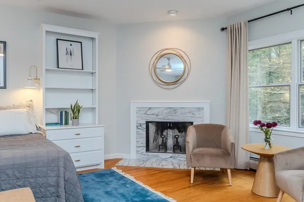 a spacious bathroom with a granite countertop sink a large mirror and a bathtub next to a window