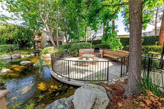 a view of a patio with a table chairs and a small yard